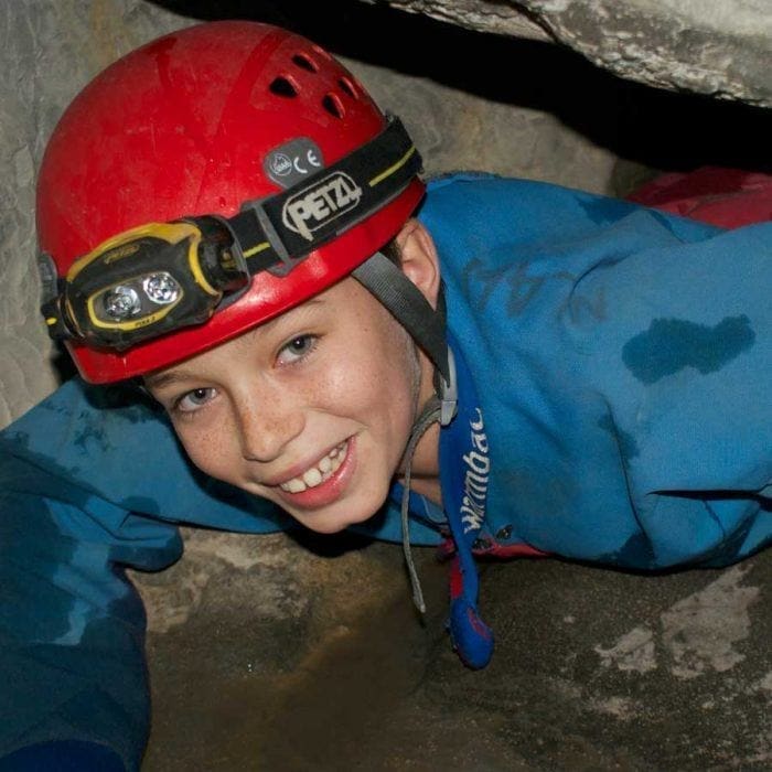 School children doing the man-made caving activity at Summit Centre, adventure centre, South Wales