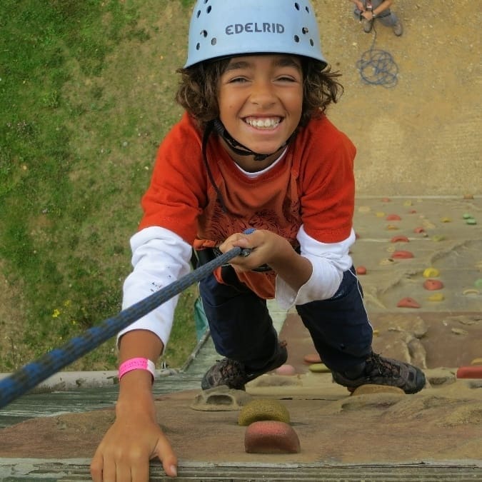 Key stage 2 and 3 school children on the climbing wall at Carroty Wood adventure centre